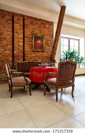 Elegance royal retro interior with stylish antique furniture and brick wall
