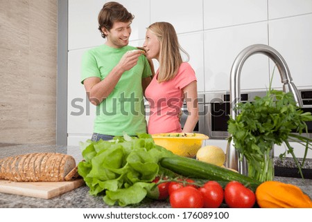 People in love eating lunch together in kitchen