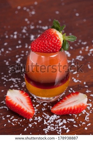 Layered fruit drink with fresh strawberries, vertical