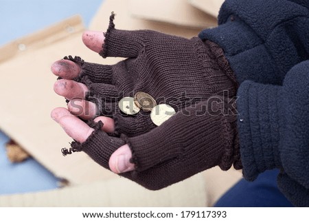 Homeless mans stretching out hands for a money