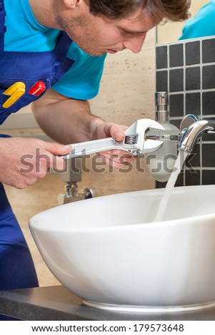Close up of plumber repairing broken faucet