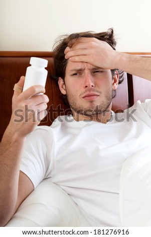 Unwell man with headache lying in bed