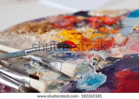 A closeup of paint brushes on a palette