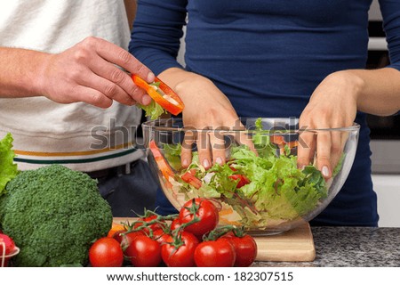 Vegan couple making a delicious salad for romantic dinner