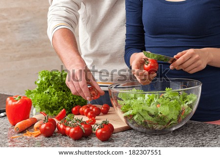Common making a salad with fresh vegetables