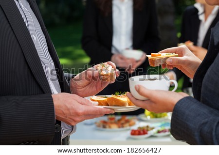 Business people who are eating lunch in the garden