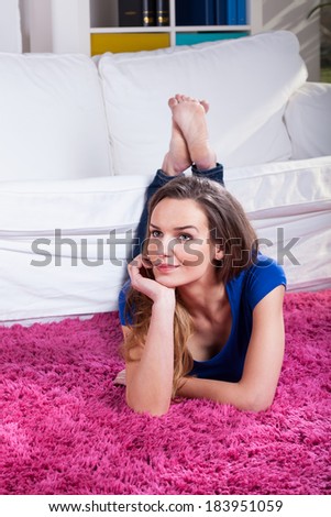 Woman laying on a pink fluffy carpet