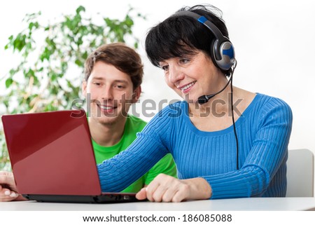 Modern woman and boy talking on video call