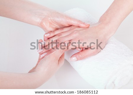 Woman\'s hand and nails oil massage at beauty salon