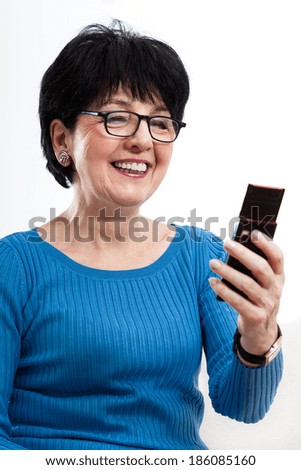 Modern elderly woman during using mobile phone