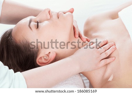Beautiful woman lying on back and relaxing at spa
