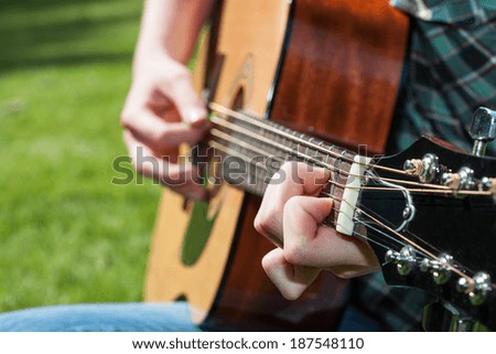A young music artist playing the classic guitar
