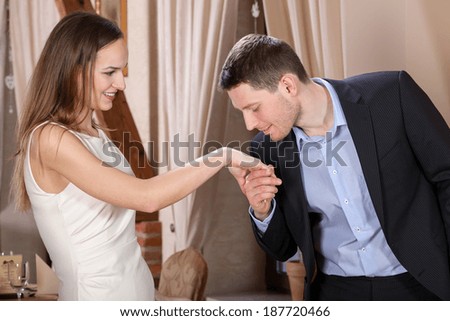Man kissing his wife\'s hand before dinner