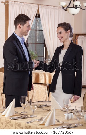 Business meeting in restaurant, two young managers