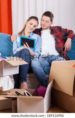 Young marriage viewing family picture during removal