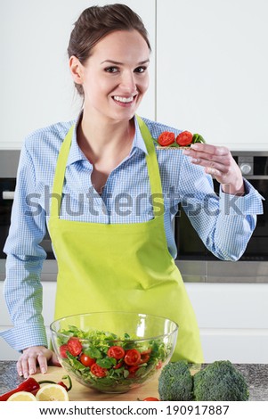 Woman with tomato salad trying sandwich with this salad