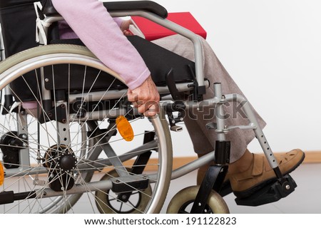 Elderly, disabled person sitting on wheelchair, horizontal
