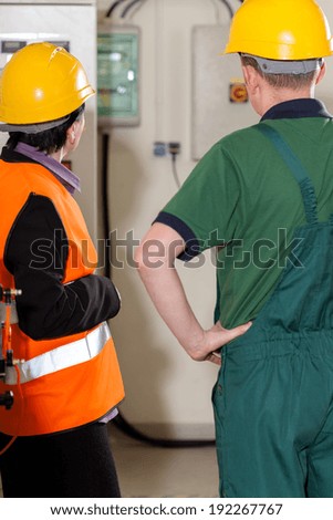 Female supervisor consulting with worker in factory