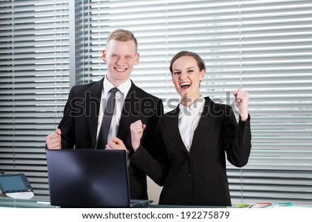 Horizontal view of successful co-workers in office