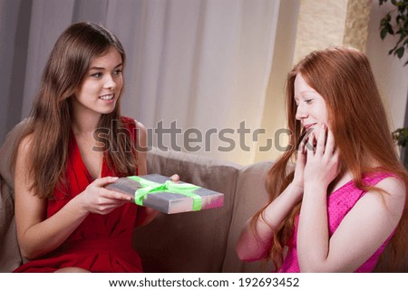 Woman giving her best friend gift for birthday