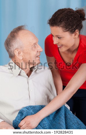 Vertical view of a woman caring about disabled man