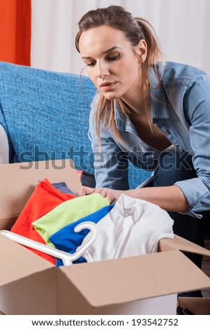 Wife packing clothes because of moving house