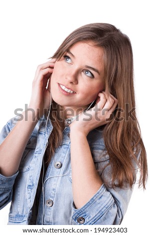 Teenage girl in denim jacket listening to music with pleasure, vertical