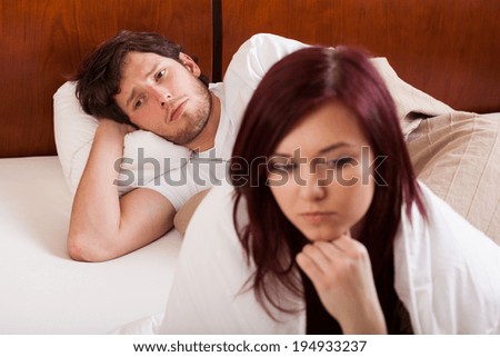 Young depressed couple having problems in bed