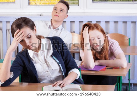 Horizontal view of bored students during lesson
