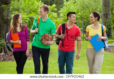 School friends coming back home through the park