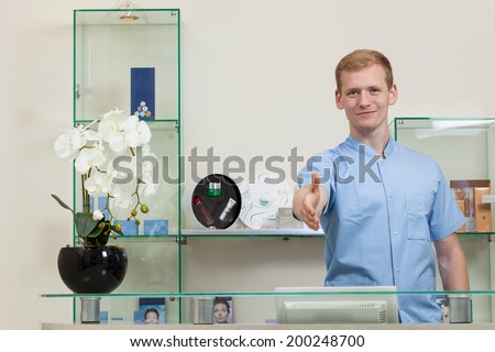 Portrait of a man holding out hand to shake hands at beauty salon