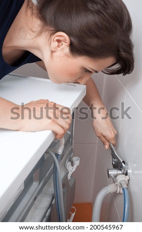 Housekeeper having problem with washing machine, vertical