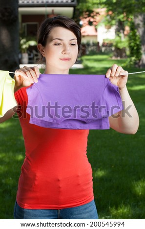 Housekeeper hanging laundry on the open air