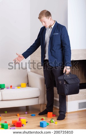 Angry businessman coming back home and see mess