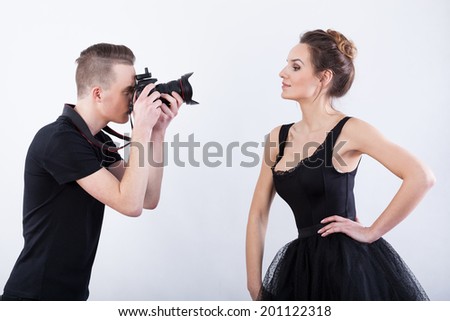 Man shooting a photo of elegant dancer, horizontal