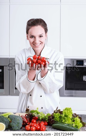 Cook shows small tomatoes in the kitchen