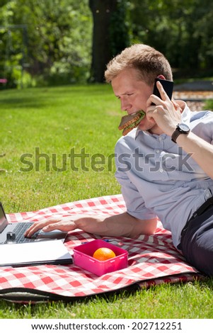 Businessman working in the garden with no time for eating
