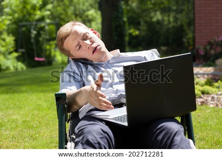 Busy businessman working with computer in the garden