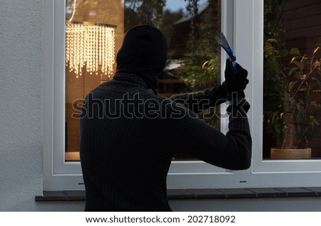 The burglar trying to break into someone\'s home