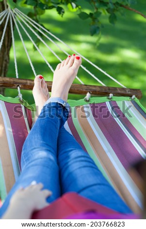 Woman relaxing on a hammock in garden