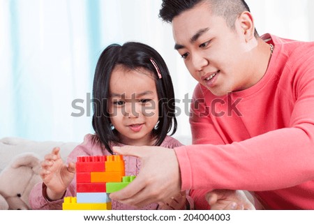 Asian girl and her dad having fun