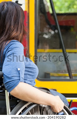 Close-up of a disabled woman on wheelchair waiting for tramway