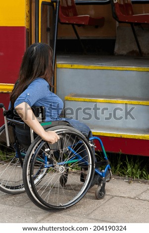 Woman of wheelchair having problem with public transport, vertical