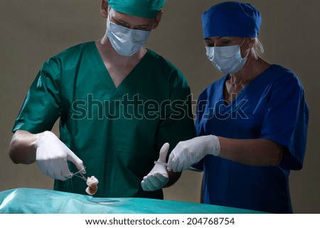 Doctors doing surgery at operating room, horizontal