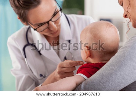 Baby boy with mother at doctor\'s office, horizontal