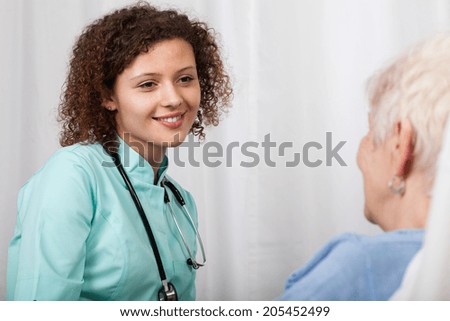 Elderly woman and her nice nurse, horizontal