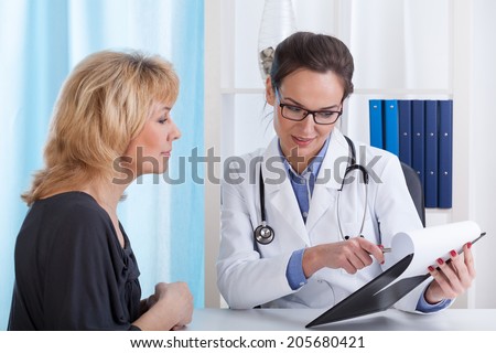 Doctor showing patient test results in office