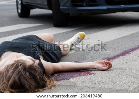 Horizontal view of woman hit by a car