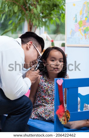 Asian pediatrician during medical appointment at home
