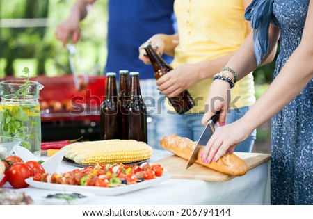 Young people enjoying good barbecue party in garden